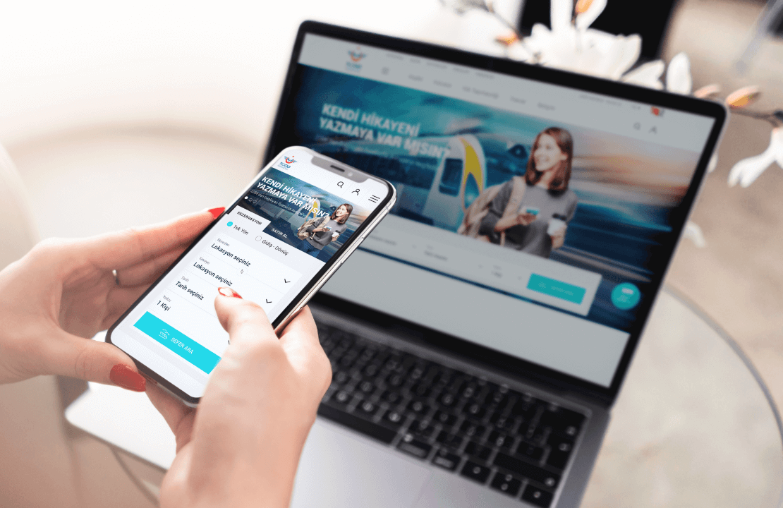 bir laptop ve telefon ekranında tcddtasimacilik.gov.tr sitesi açık